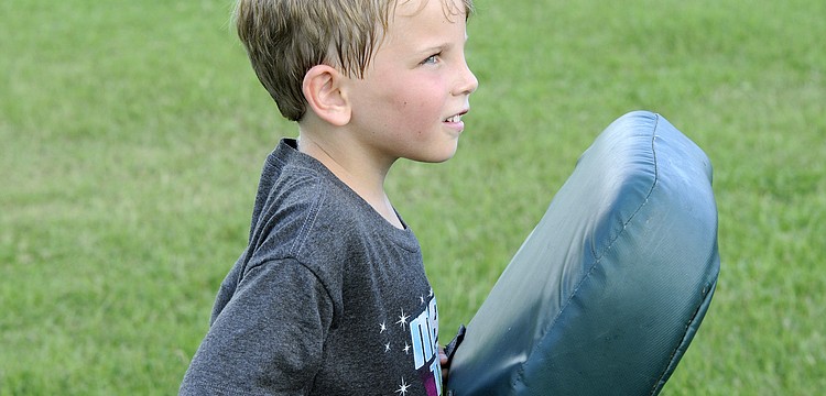 Six-year-old Kayden Carroll enjoyed smashing into people during the offensive line drills.