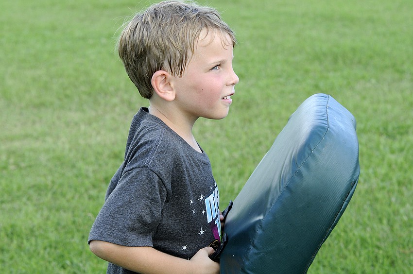 Six-year-old Kayden Carroll enjoyed smashing into people during the offensive line drills.