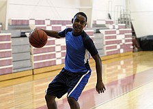 Booker Middle School eighth-grader Deric DuBose dribbles the ball down the lane.