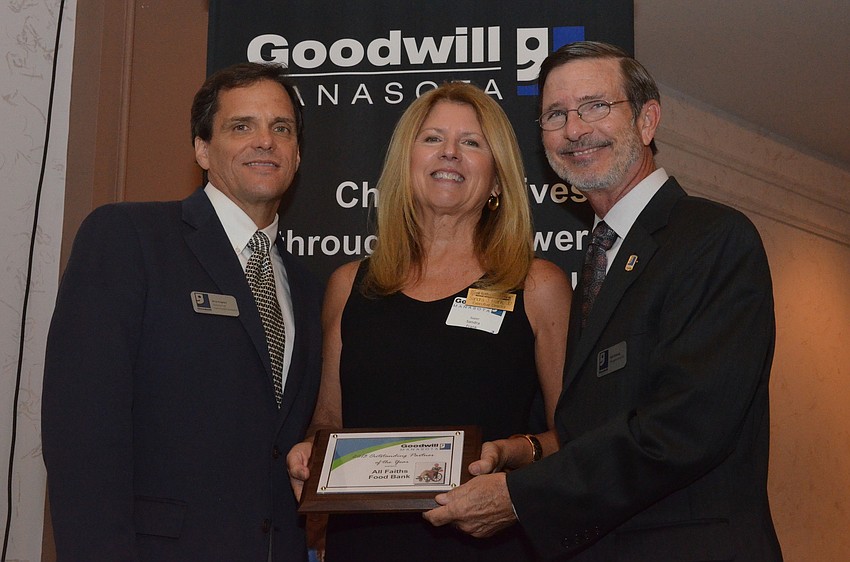 Sandra Frank with All Faiths Food Bank accepted the 2013 Outstanding Partner of the Year award from Rick Hughes and Bob Rosinsky.
