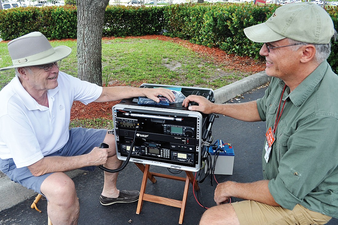 Amateur radio operators Roger Byron and Ed Skalecki sit by ByronÃ¢â‚¬â„¢s go-box, which holds six radios he uses to communicate when he is dispatched to an emergency.