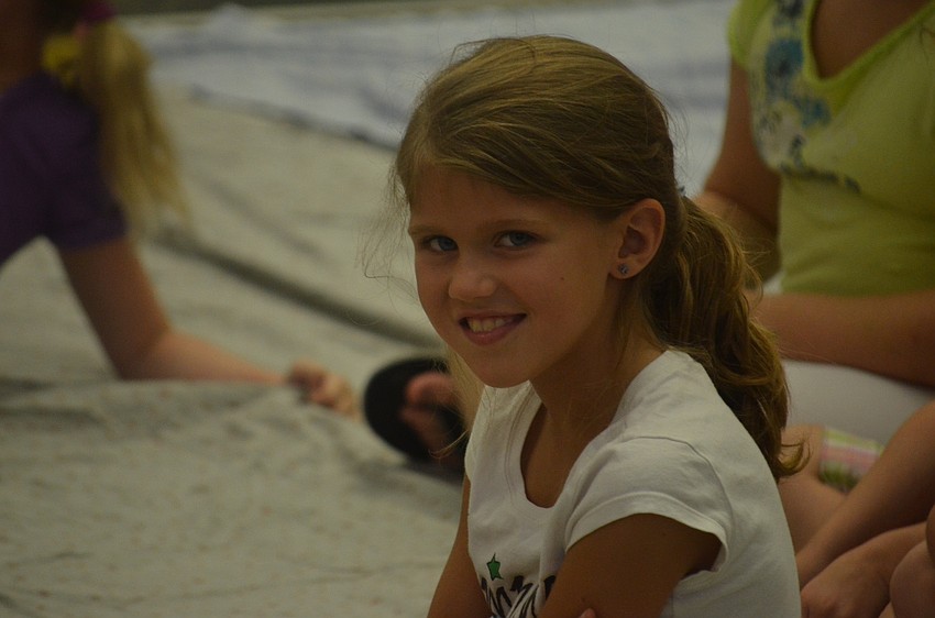 Elyse Krueger, 7, waits for the Scott Humston magic show to begin.