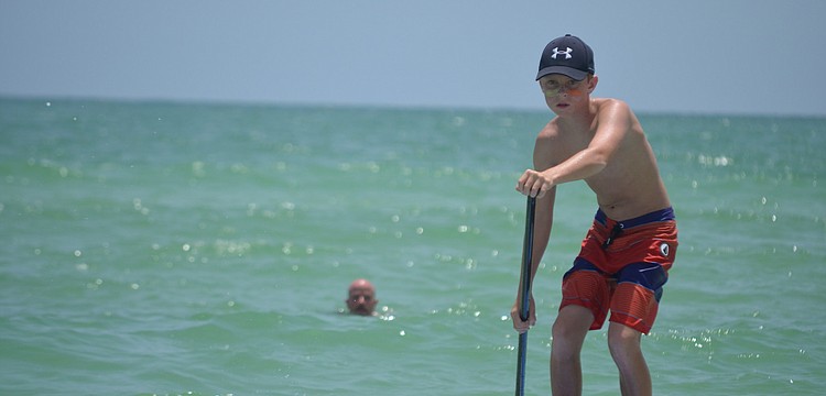 A.J. Grande paddles at the Kids Demo on Siesta Key Beach.