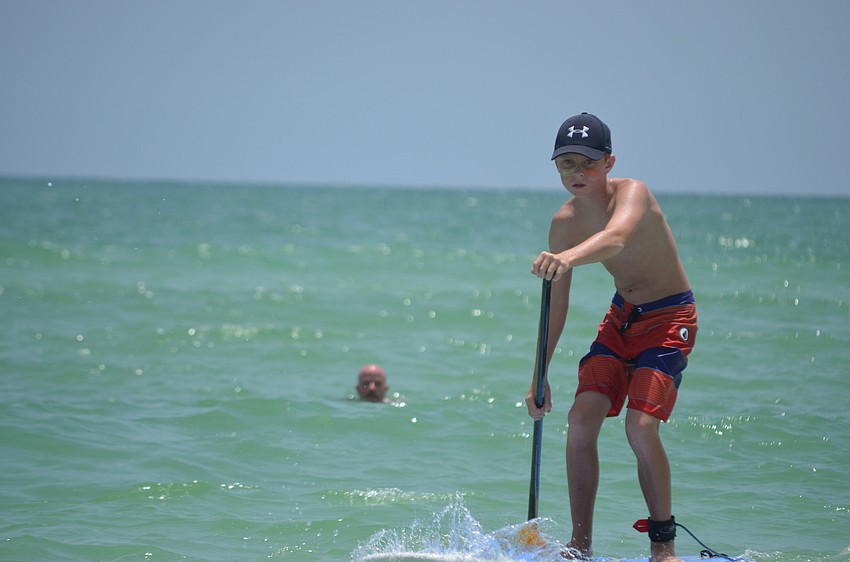 A.J. Grande paddles at the Kids Demo on Siesta Key Beach.