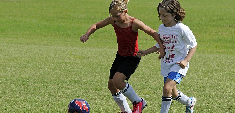 Callista Marquette, 8, and Jenny Cotton, 9, battle for position during team wars.
