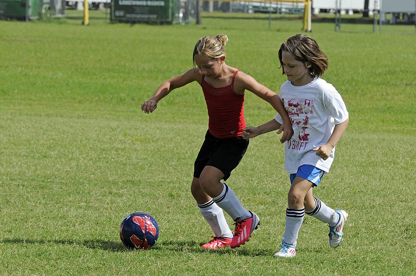 Callista Marquette, 8, and Jenny Cotton, 9, battle for position during team wars.