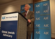 Rabbi Andy Baker greets community members as he begins his talk.