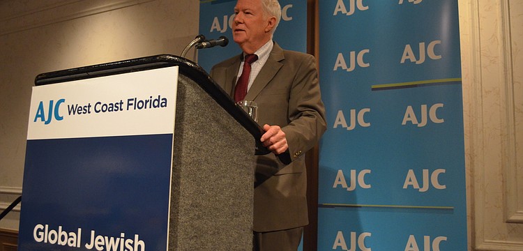 Rabbi Andy Baker greets community members as he begins his talk.