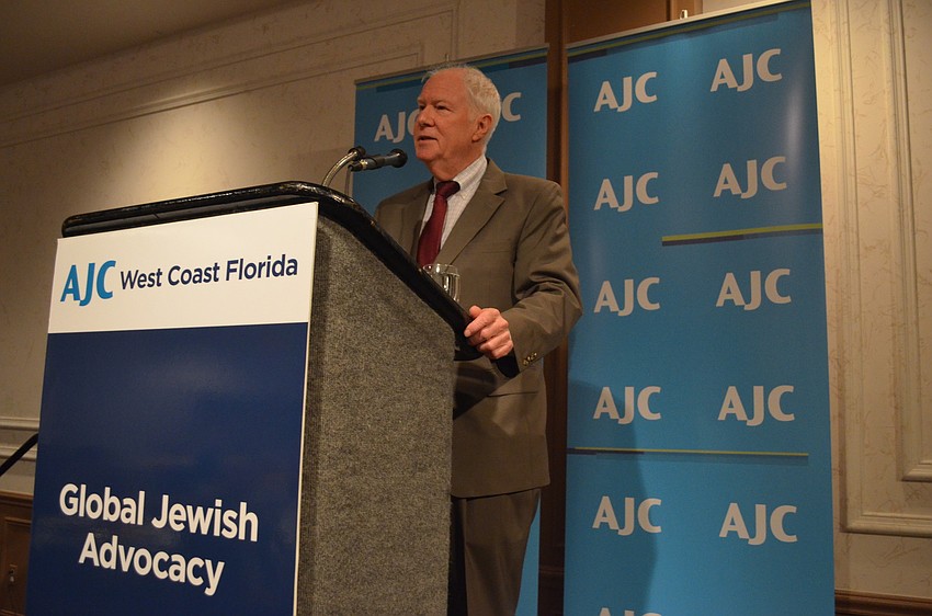 Rabbi Andy Baker greets community members as he begins his talk.