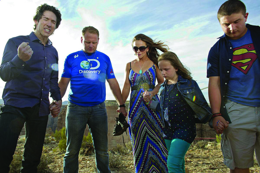 Minister Joel Osteen, left, leads Nik Wallenda and his family in prayer minutes before the Grand Canyon walk. (Photo from Salon.com)