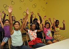 The girls team readies for a game of â€œstay-in-your-chairâ€ volleyball.