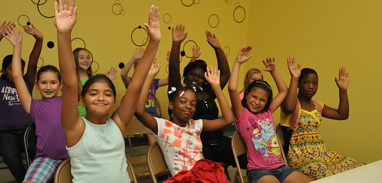 The girls team readies for a game of â€œstay-in-your-chairâ€ volleyball.