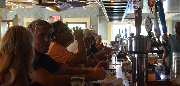 The bar at Tommy Bahama was packed with people for the extended happy hour from 3 to 7 p.m.