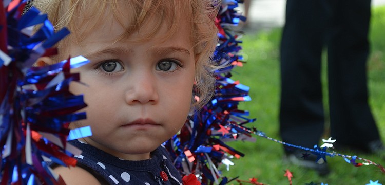 Blaise Fluker, 21 months, rides in a wagon in the parade.