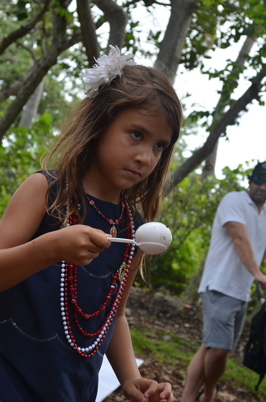 Cielo Trujillo, 6, participates in the egg race.