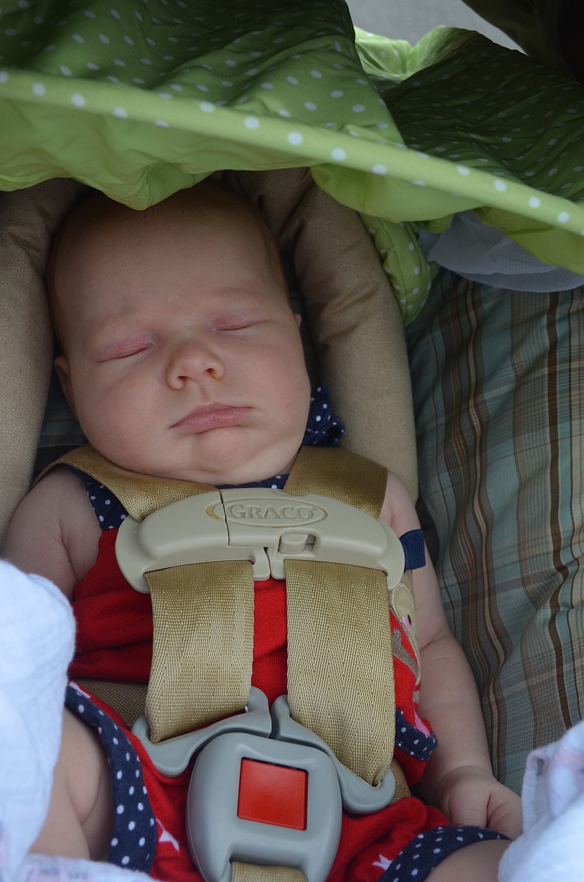 Giuliana Bankert, 1 month, sleeps through the parade.