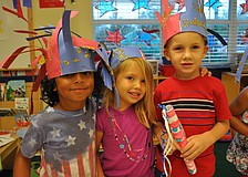 Robby Koski, Lindsey Lemler and Enzo Knap smile before their parade starts.