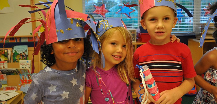 Robby Koski, Lindsey Lemler and Enzo Knap smile before their parade starts.