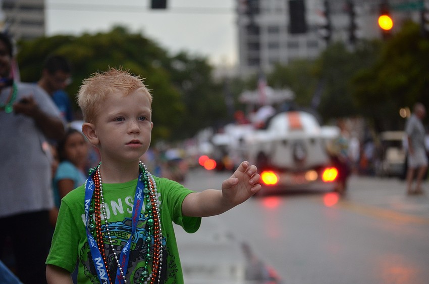 Hayden Hackler, 4, reaches out to get more beads.