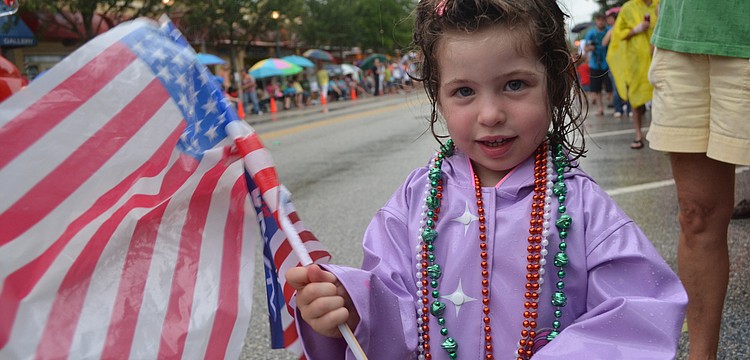 Reagan Russo, 3, didn't let the rain stop her from showing off her patriotism and watching the parade.