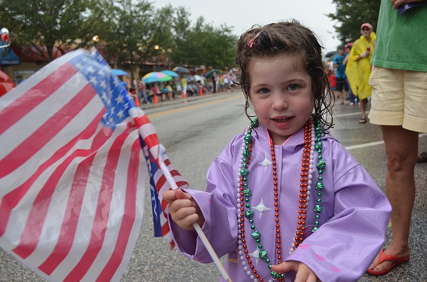 Reagan Russo, 3, didn't let the rain stop her from showing off her patriotism and watching the parade.