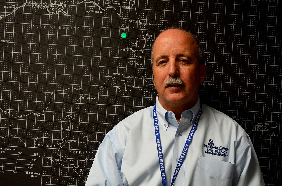 Emergency Management Chief Ed McCrane stands near the hurricane-tracking chart in the Sarasota County administration building.