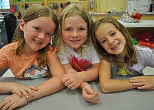 Reagan Ryckman, Jessica Heuring and Anna Weidel prepare to make bridges out of toothpicks and marshmallows.