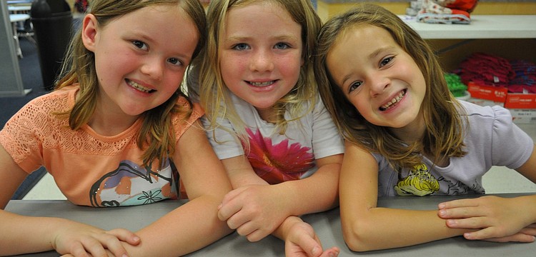 Reagan Ryckman, Jessica Heuring and Anna Weidel prepare to make bridges out of toothpicks and marshmallows.