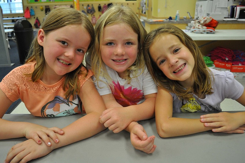 Reagan Ryckman, Jessica Heuring and Anna Weidel prepare to make bridges out of toothpicks and marshmallows.