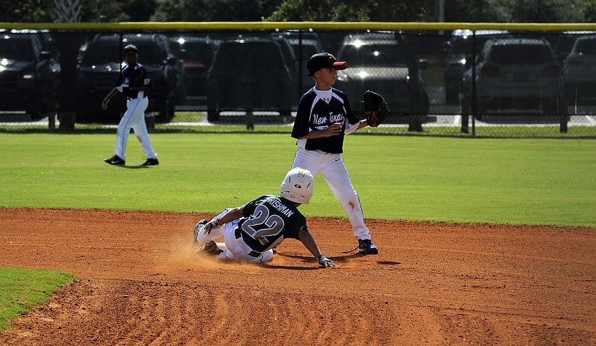 Stone Frishman slides safely into second base after hitting a leadoff double against New Tampa July 13.