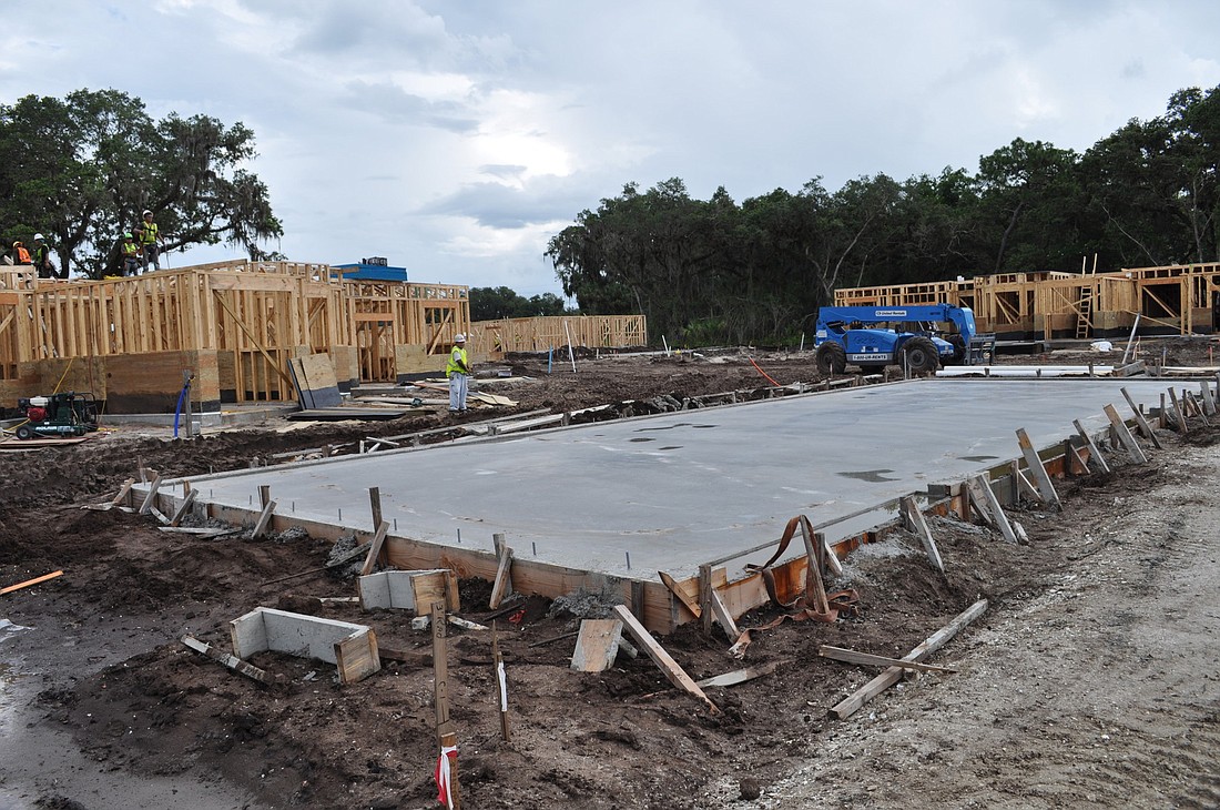 Contractors already have begun framing several apartment buildings and pouring slabs for other structures, such as this future parking garage.