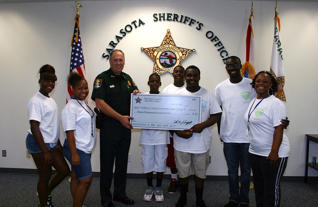 On Tuesday, July 16, Sheriff Tom Knight presented a check for $3,000 to Brothers and Sisters Doing the Right Thing, a non-profit group that provides tutoring and summer camps for local kids.