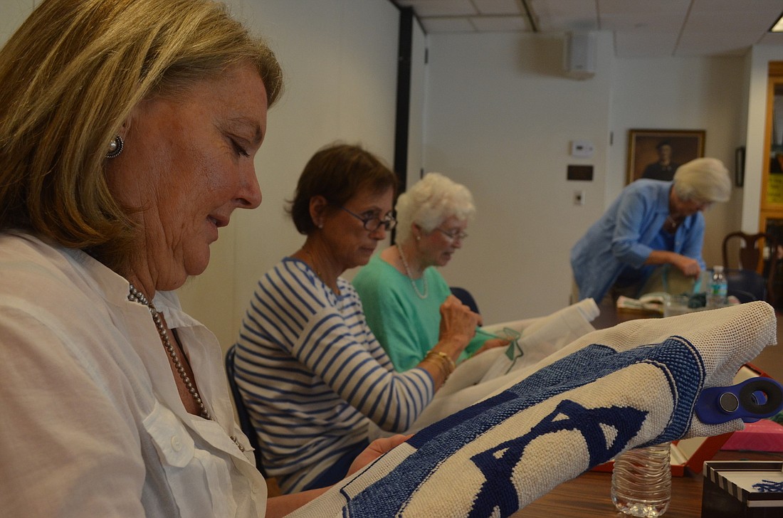 Edye Morton works on a Star of David kneeler that will go in the choir area. She has been doing needlepoint with the group for two years.