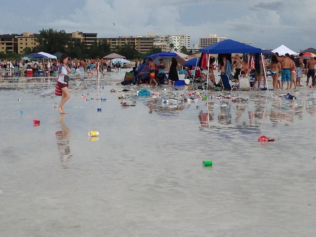 Rain and flooding on the Fourth of July caused trash from the large crowds to be strewn about on Siesta Key Beach.