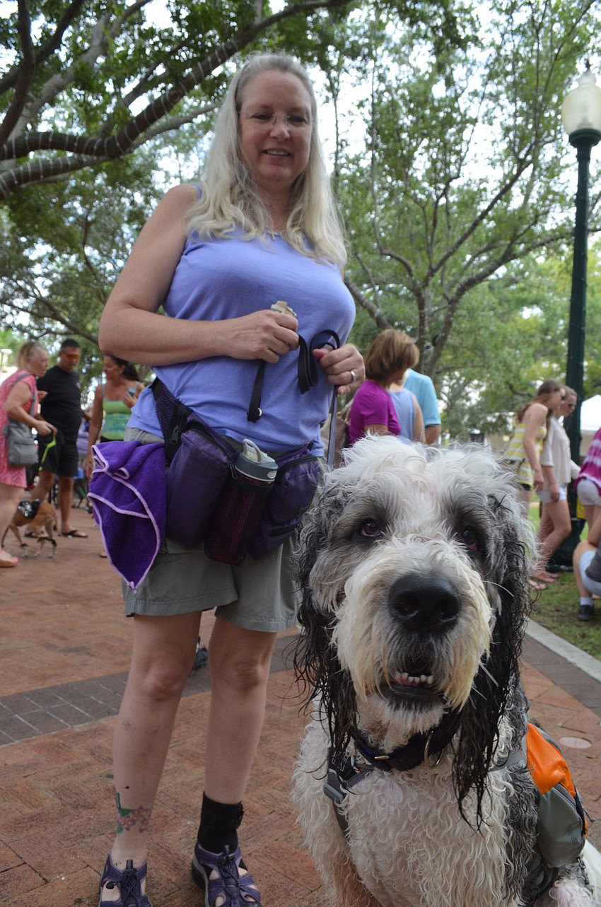Jeanine Brawn is a dog trainer. She has a St. Berdoodle named B.E.N. or Being Enthusiastically Noble. He is a hybrid between a St. Bernard and a standard poodle. He carries an icepack in his backpack to keep him cool.