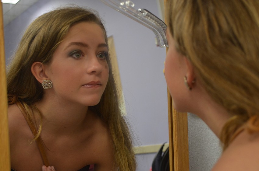 Model Jainey Howard checks her makeup before the fashion show.