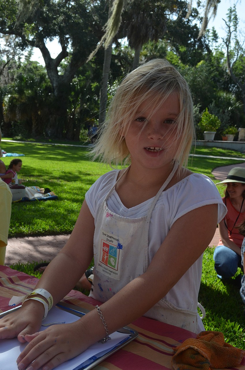 Jenavieve McDonnell, 8, makes her project.