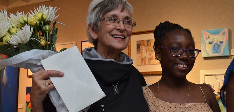 Organizer of the event Judy Alexander receives flowers from the girls involved, such as, model Zeneya Matthews