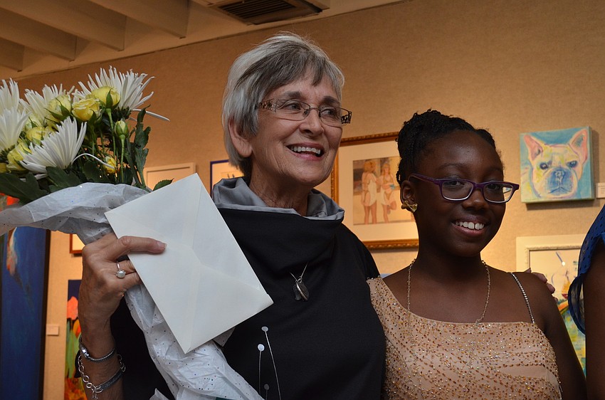 Organizer of the event Judy Alexander receives flowers from the girls involved, such as, model Zeneya Matthews