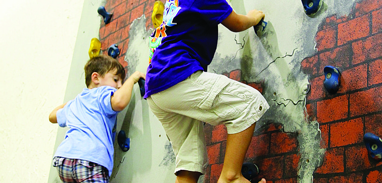 Reece Wilson and Jeremia Hernandez show no fear climbing to the top of the rock wall.