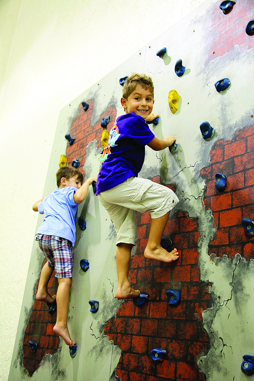 Reece Wilson and Jeremia Hernandez show no fear climbing to the top of the rock wall.