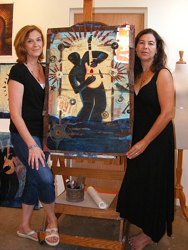 Mary GrandPre and Paula Murray pose with the 2012 Bradenton Blues Fest poster.