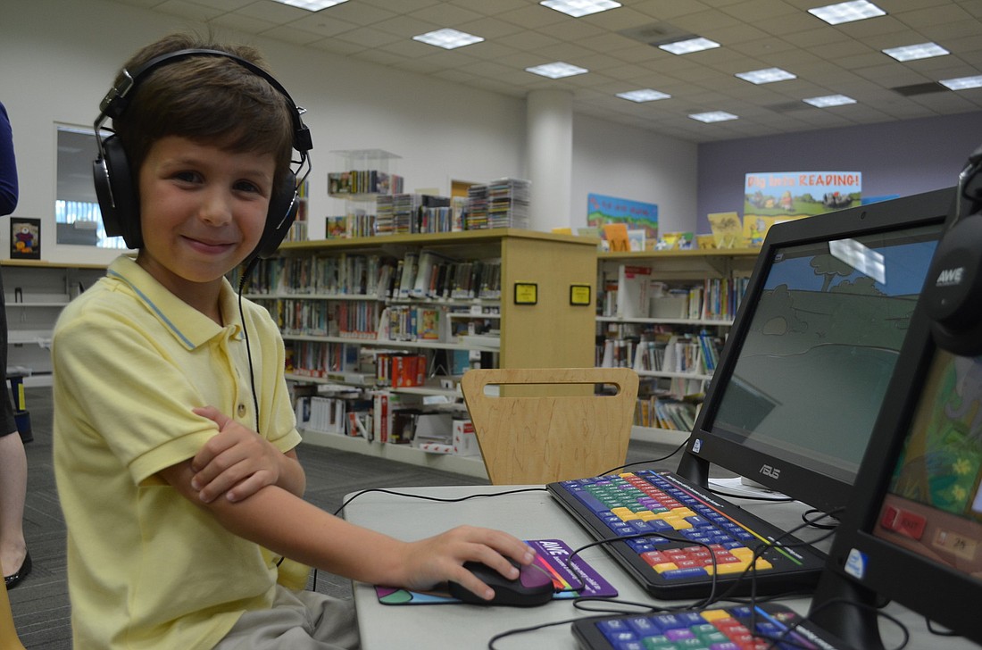 Gianluca Mastroianni, 5, loves to play on the AWE Early Literacy Learning Station. He demonstrates the games he plays to library staff and board members.