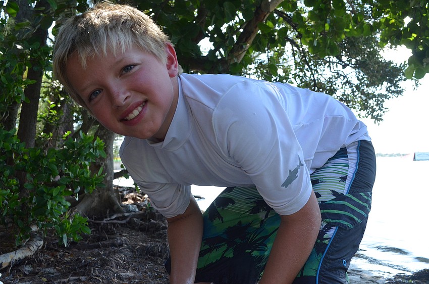 Tyler Rodeghiero, 10, examines the creatures campers caught.