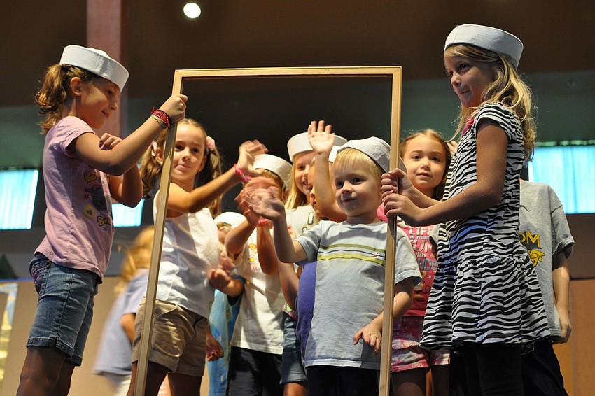 Children act out a living museum exhibit.