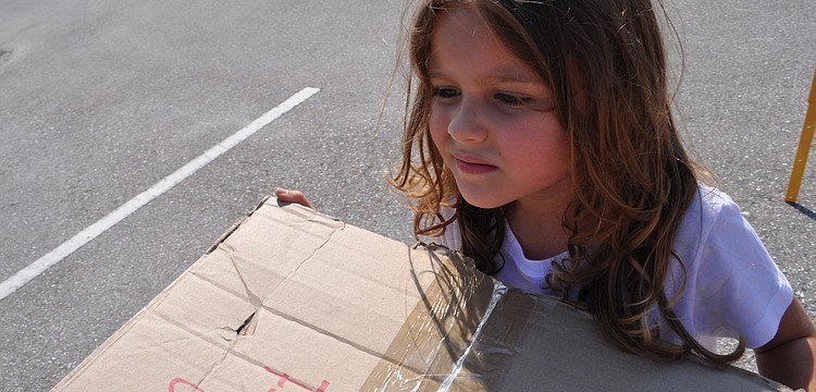 Athena Henson, 4, helps to build the wall of Jericho.