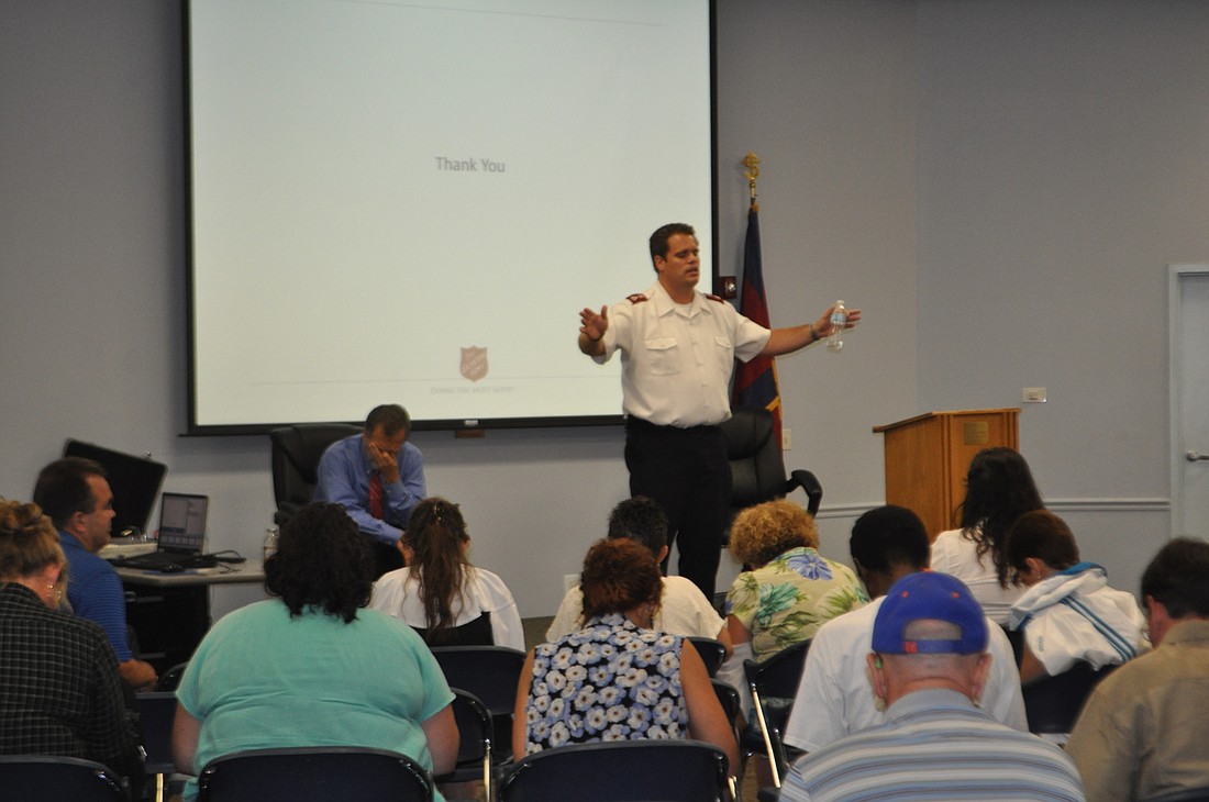 Salvation Army area commander Ethan Frizzell leads the audience in prayer following a town hall meeting about the organizationÃ¢â‚¬â„¢s strategies to combat homelessness.