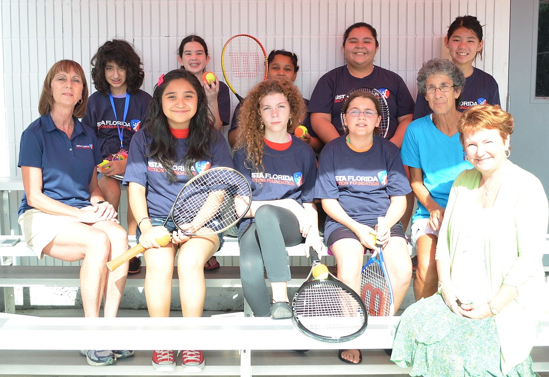 USTA Florida Section Foundation Executive Director Linda Curtis, volunteer tennis instructor Maxine Spitzer and Girls Inc. Executive Director Robin Rose with some of the Girls Inc. Summer Camp attendees.