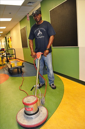 Braden River Elementary head custodian Calvin Johnson readies to clean a hallway.