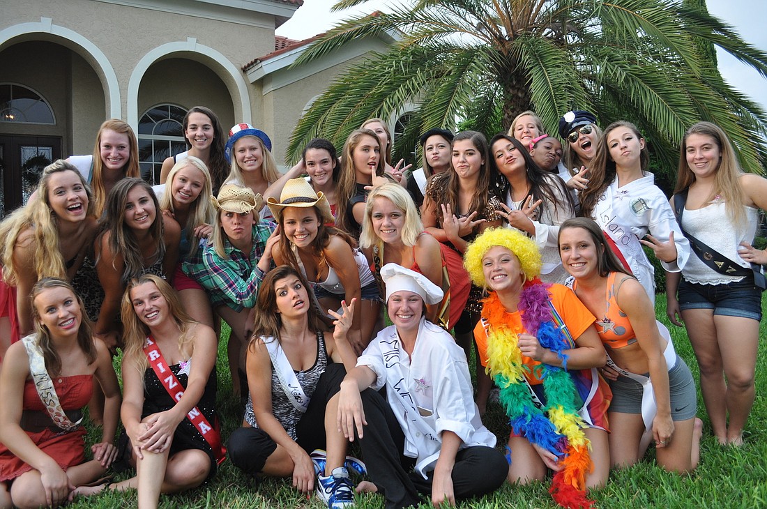 The Braden River High varsity cheerleading team dresses in character for a Miss USA Pageant at the home of one of the cheerleaders.